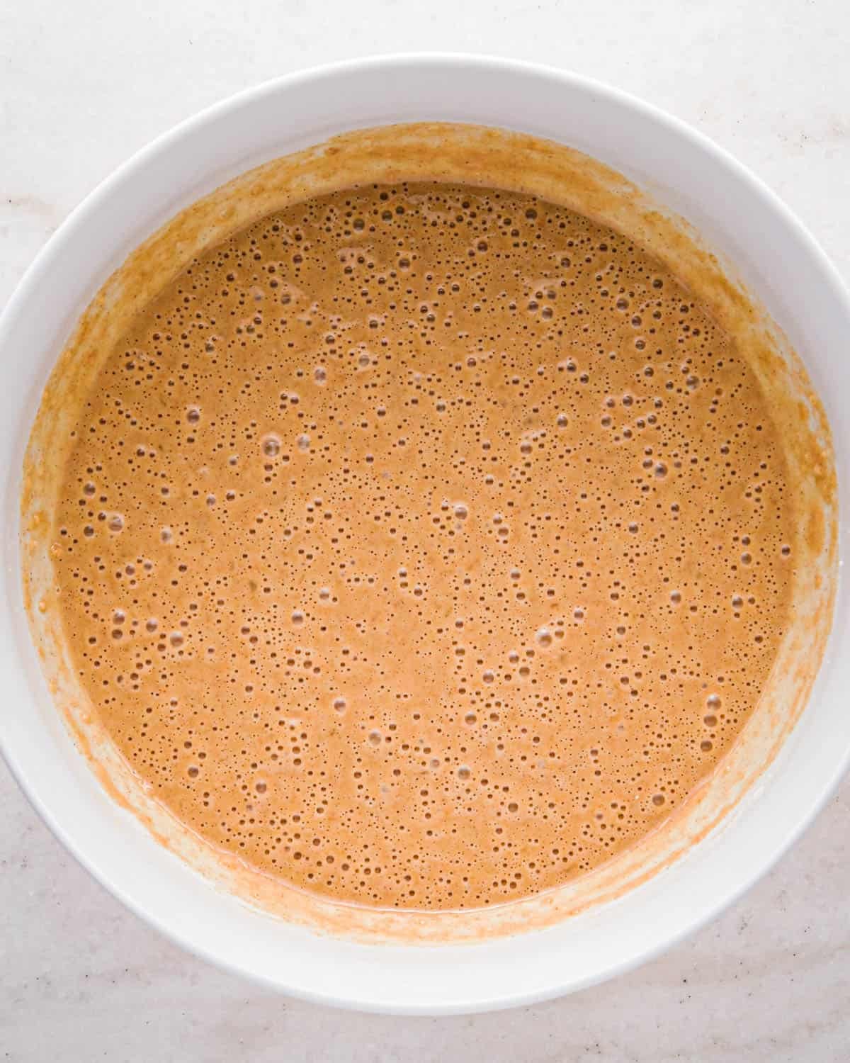 making oatmeal chocolate chip muffins - batter in a white bowl