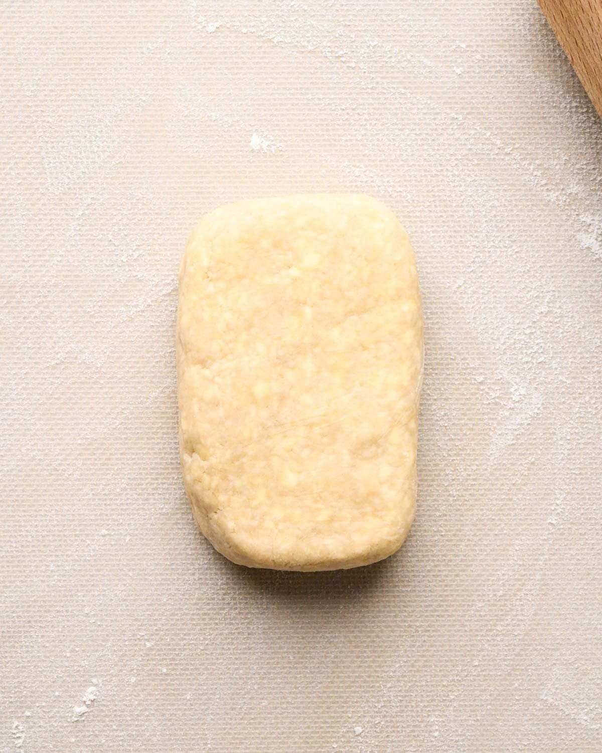 making apple hand pies crust - one rectangle of dough after being chilled on a floured silicone baking mat