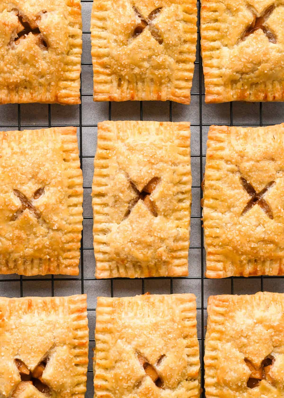 9 baked apple hand pies on a wire cooling rack
