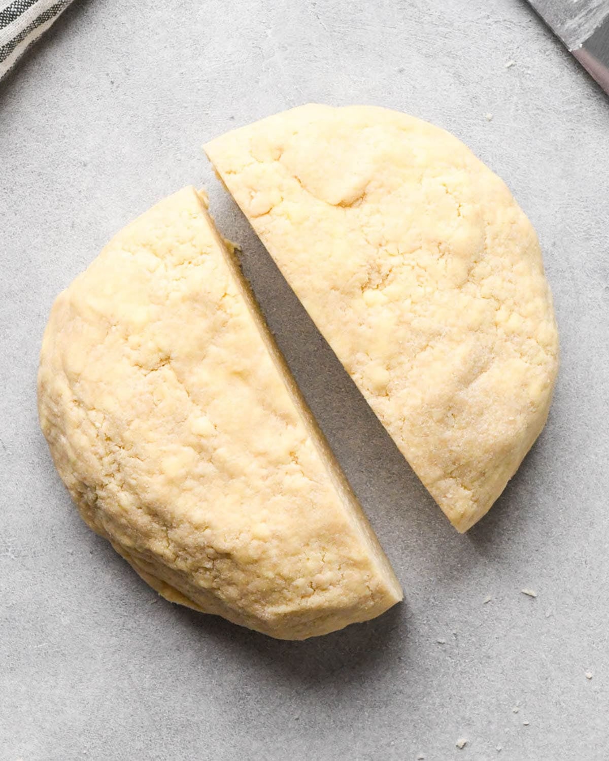 making apple hand pies crust - round disc of dough cut in half from top to bottom