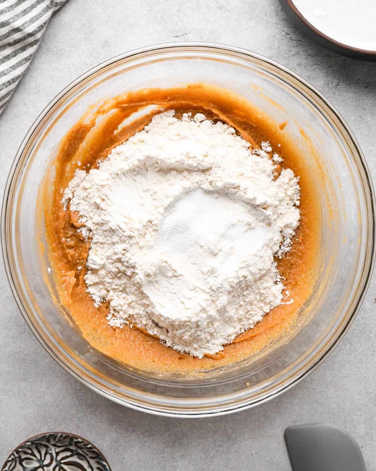 making peanut butter blondies - flour, baking soda and salt added to the batter