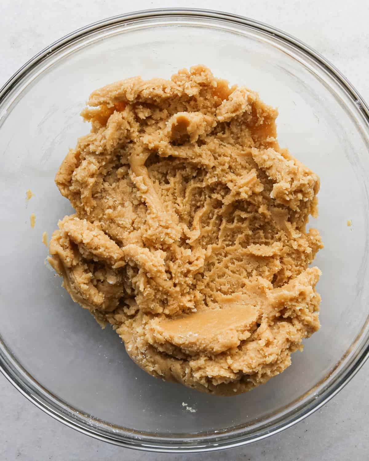 making brown butter cookie bars - dough in a glass mixing bowl