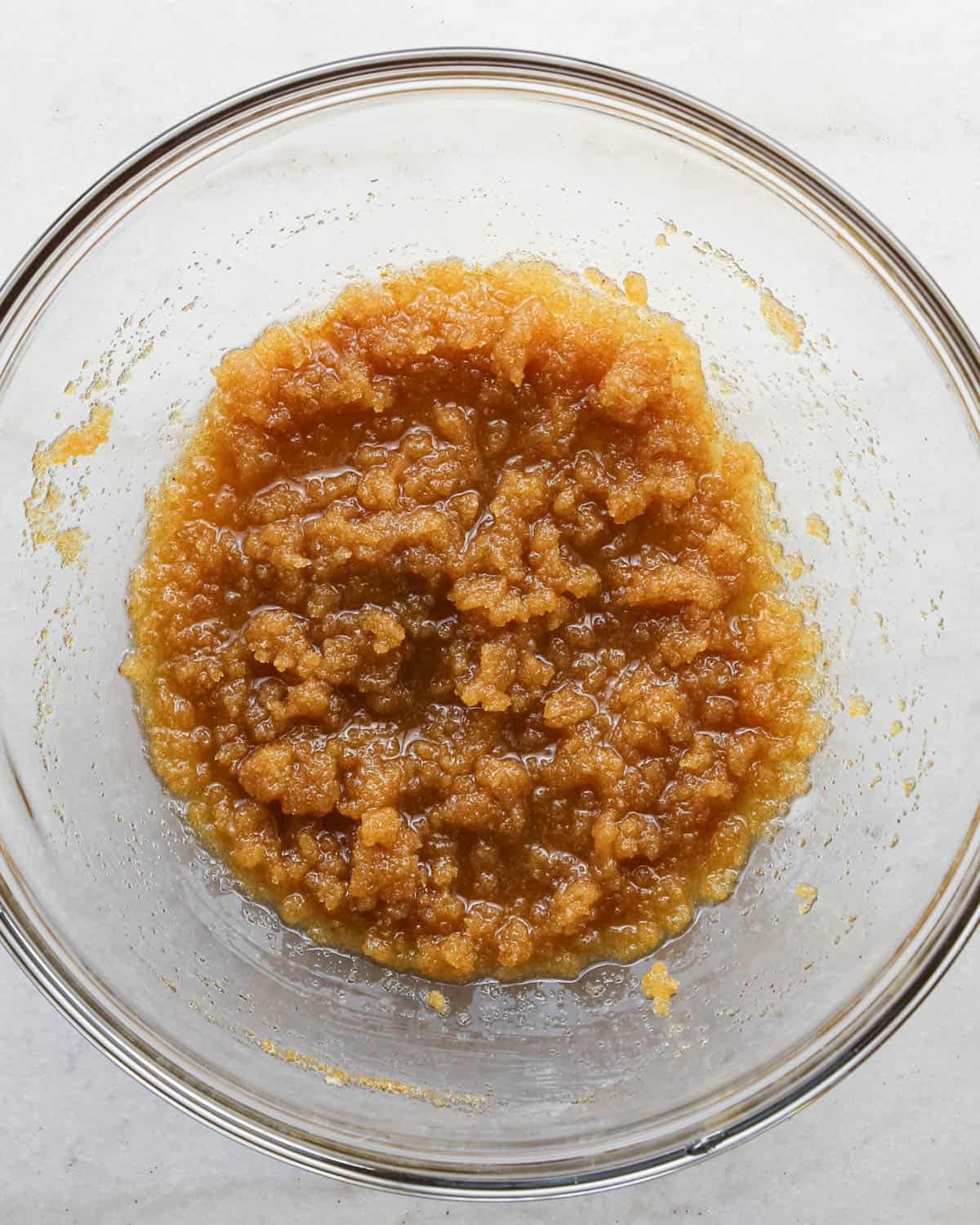 making brown butter cookie bars - browned butter and sugar mixed together in a glass mixing bowl.