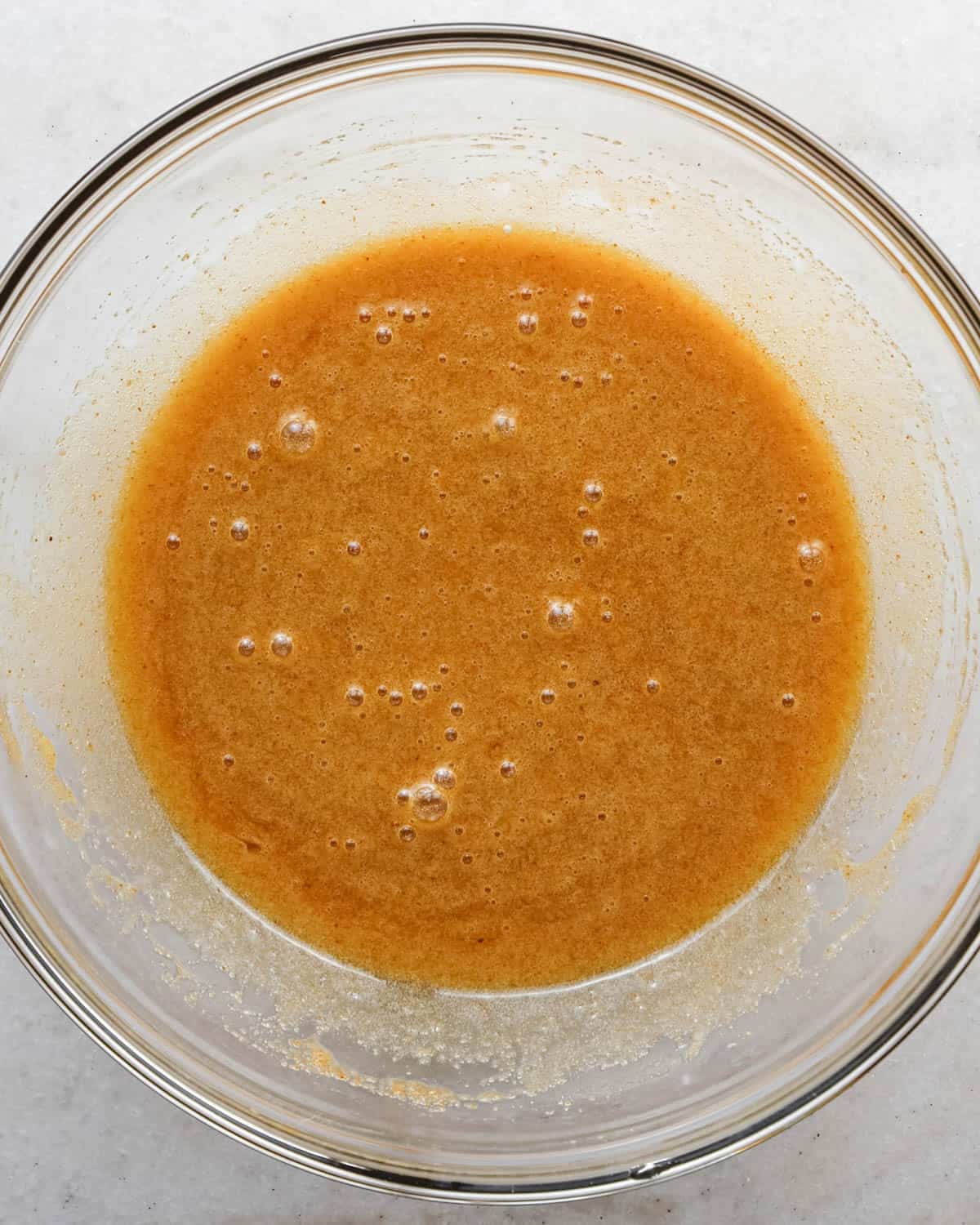 making brown butter cookie bars - wet ingredients in a glass mixing bowl