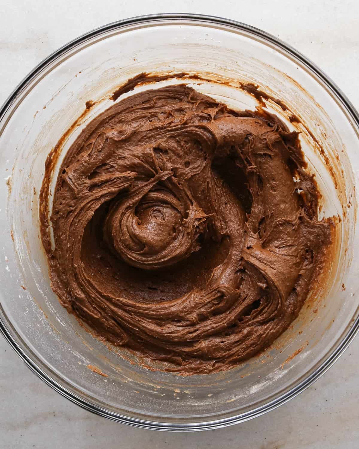 making candy halloween brownies - brownie batter in a glass mixing bowl