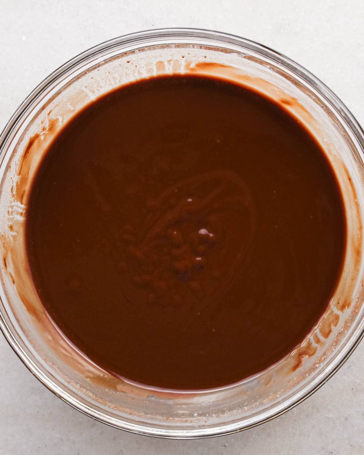 making candy halloween brownies - melted butter and chocolate in a glass mixing bowl