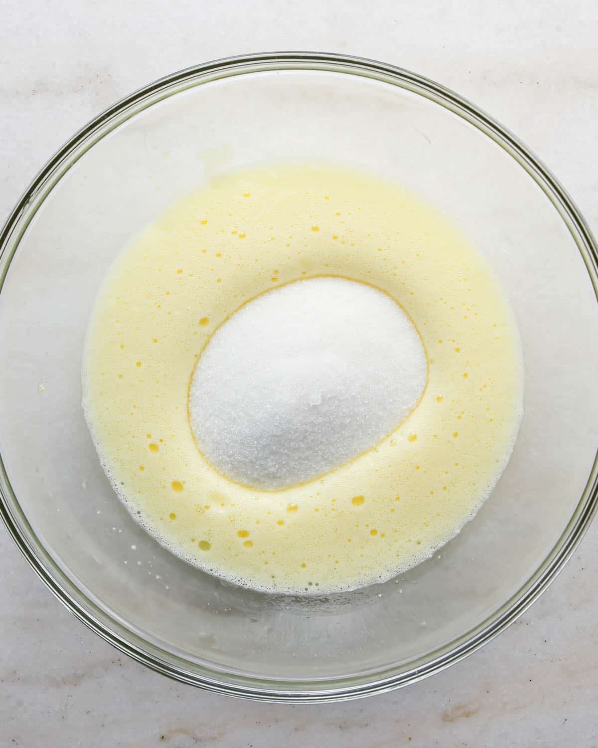making candy halloween brownies - beaten eggs and sugar in a glass mixing bowl before mixing