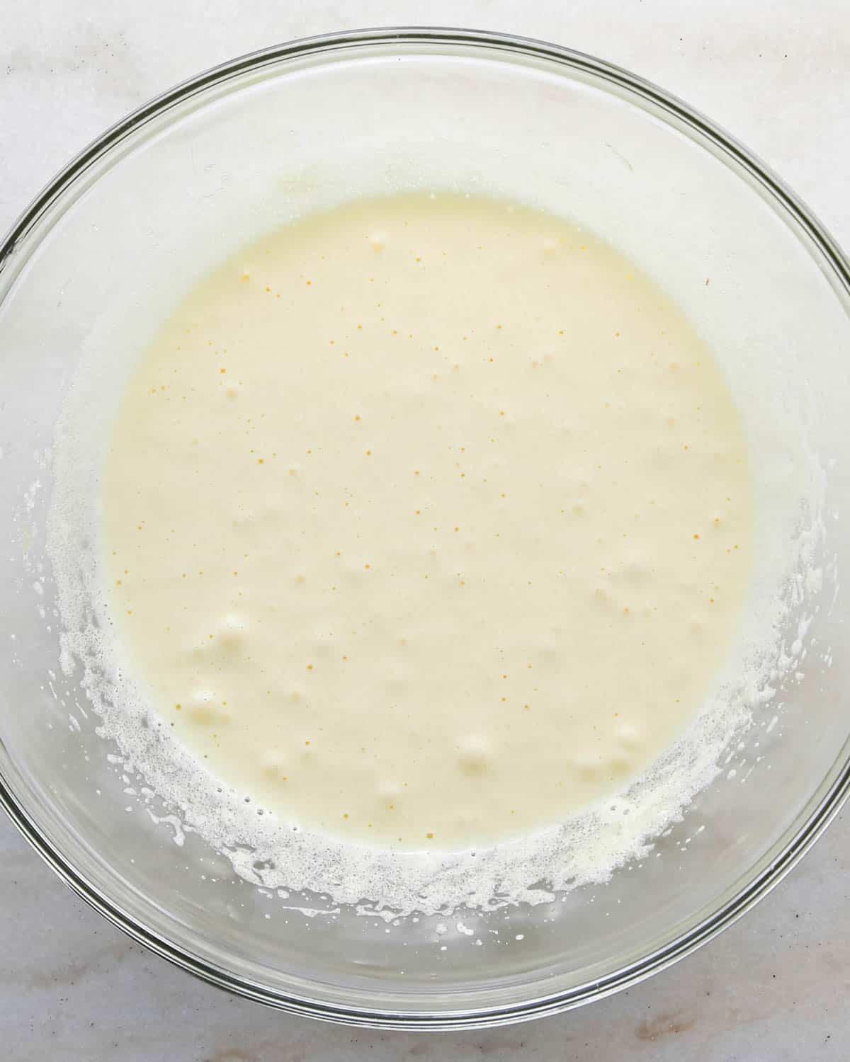 making candy halloween brownies - eggs and sugar in a glass mixing bowl after beating for 1 minute