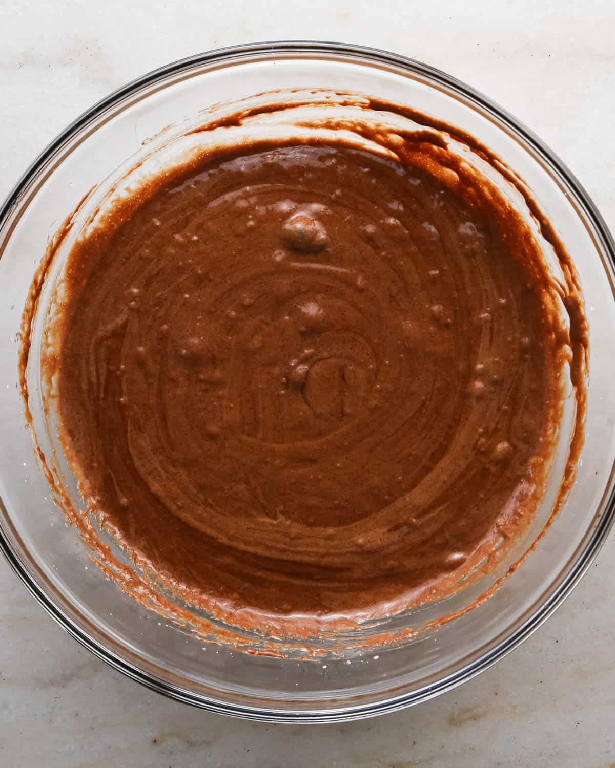making candy halloween brownies - wet ingredients in a glass mixing bowl
