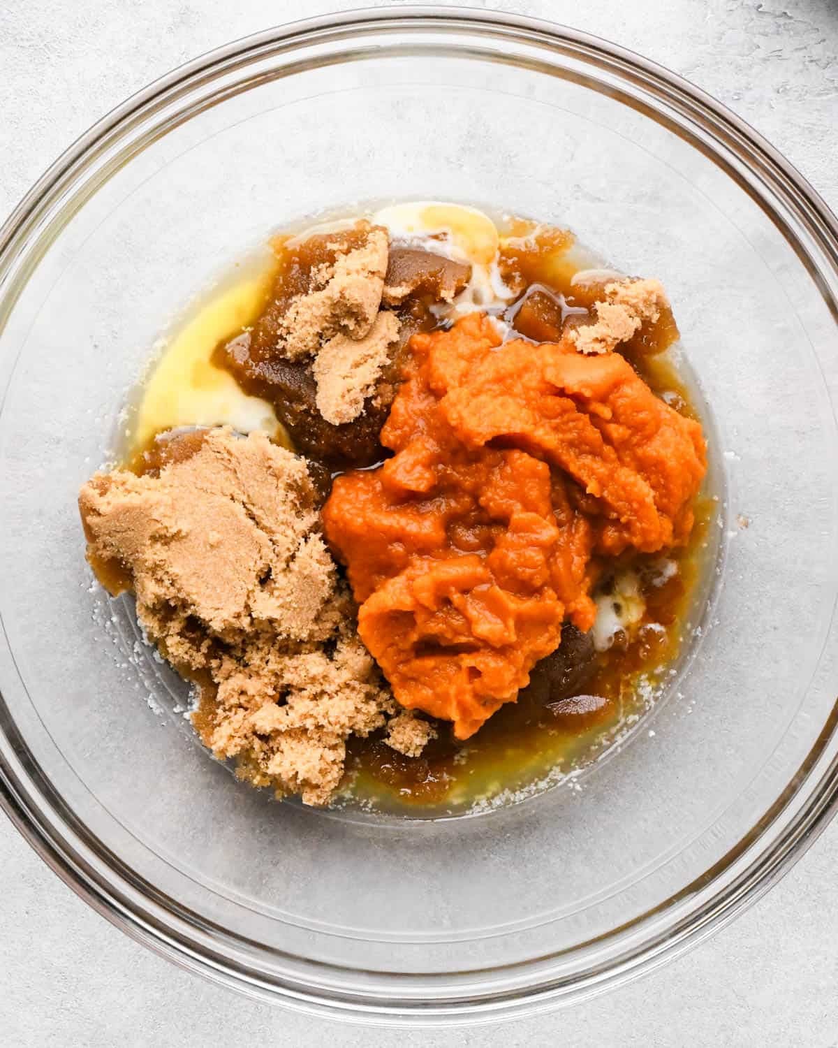 making pumpkin blondies - melted butter, brown sugar, pumpkin puree and vanilla in a glass mixing bowl before mixing