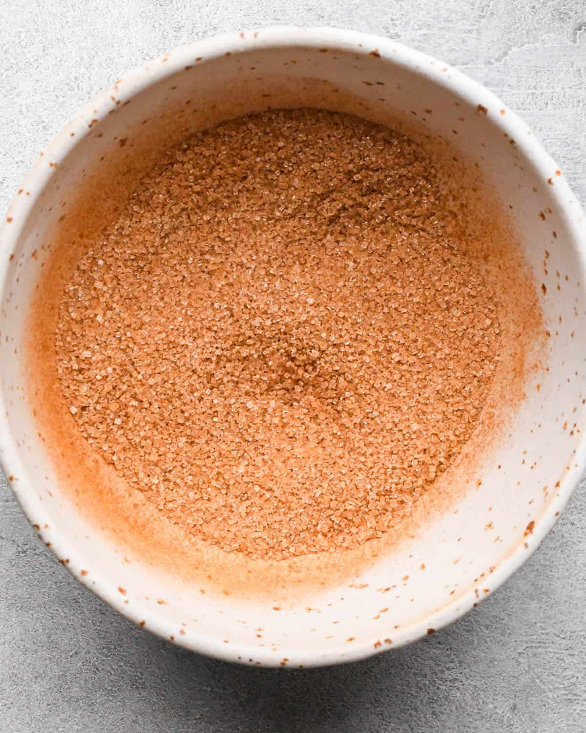 making snickerdoodle blondies -cinnamon sugar in a small ceramic bowl