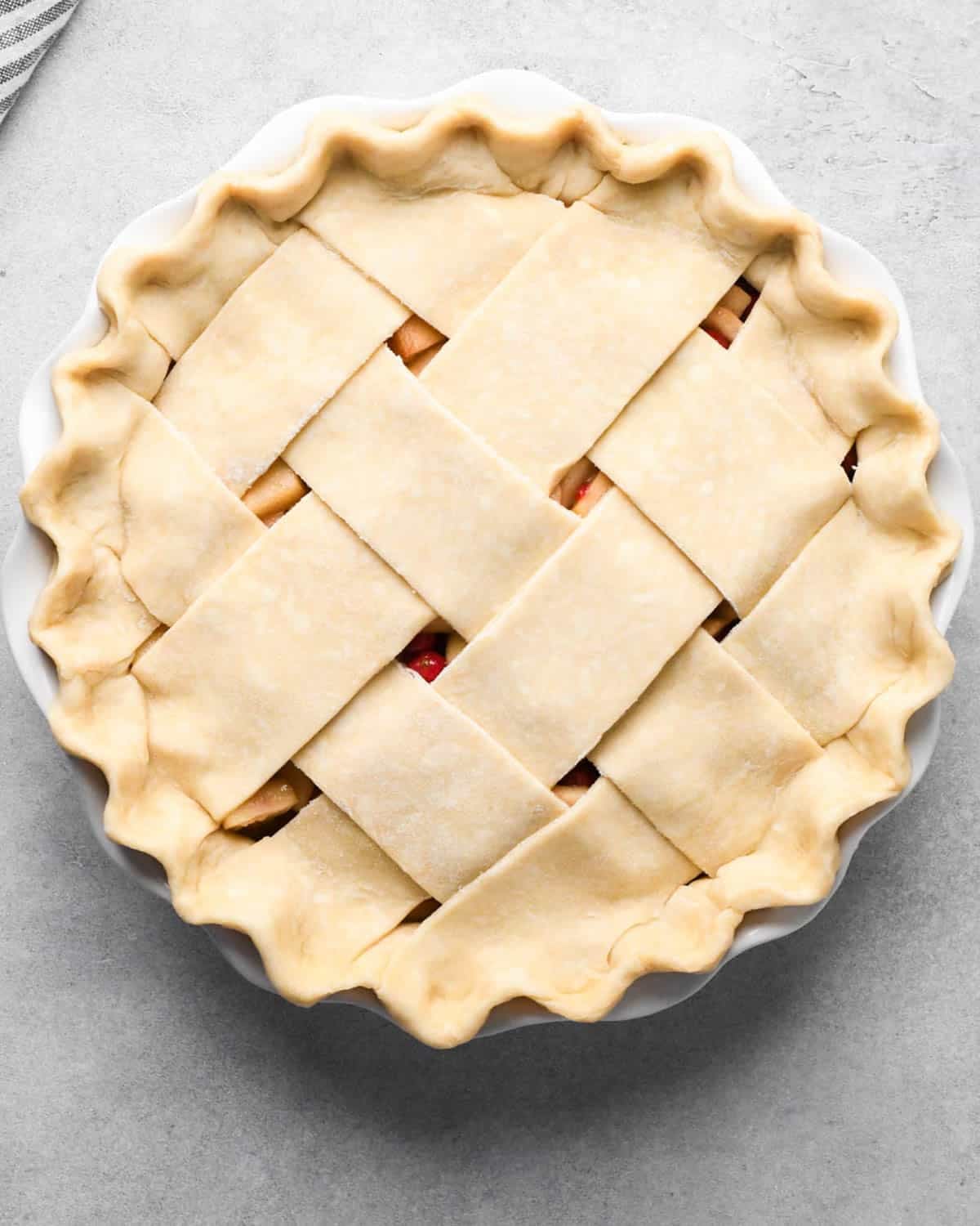 assembled apple cranberry pie with a lattice crust before baking