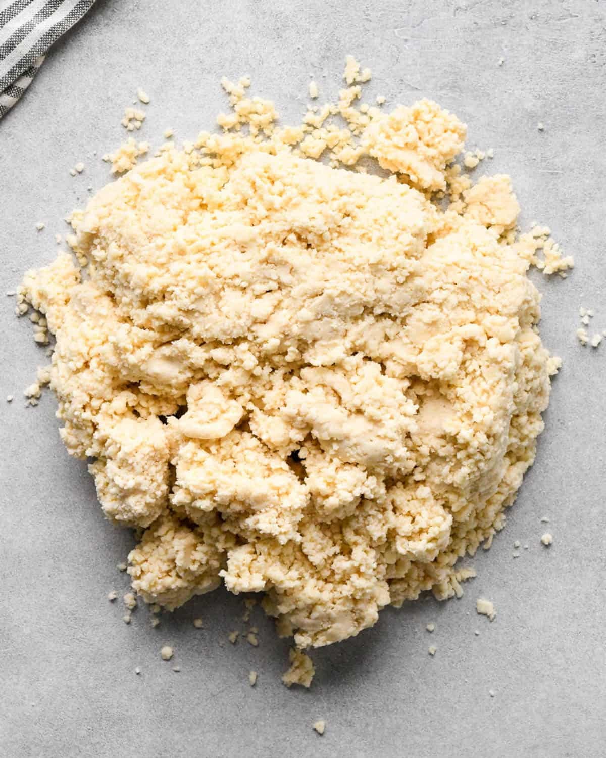 making apple cranberry pie crust - crust mixture on a gray surface