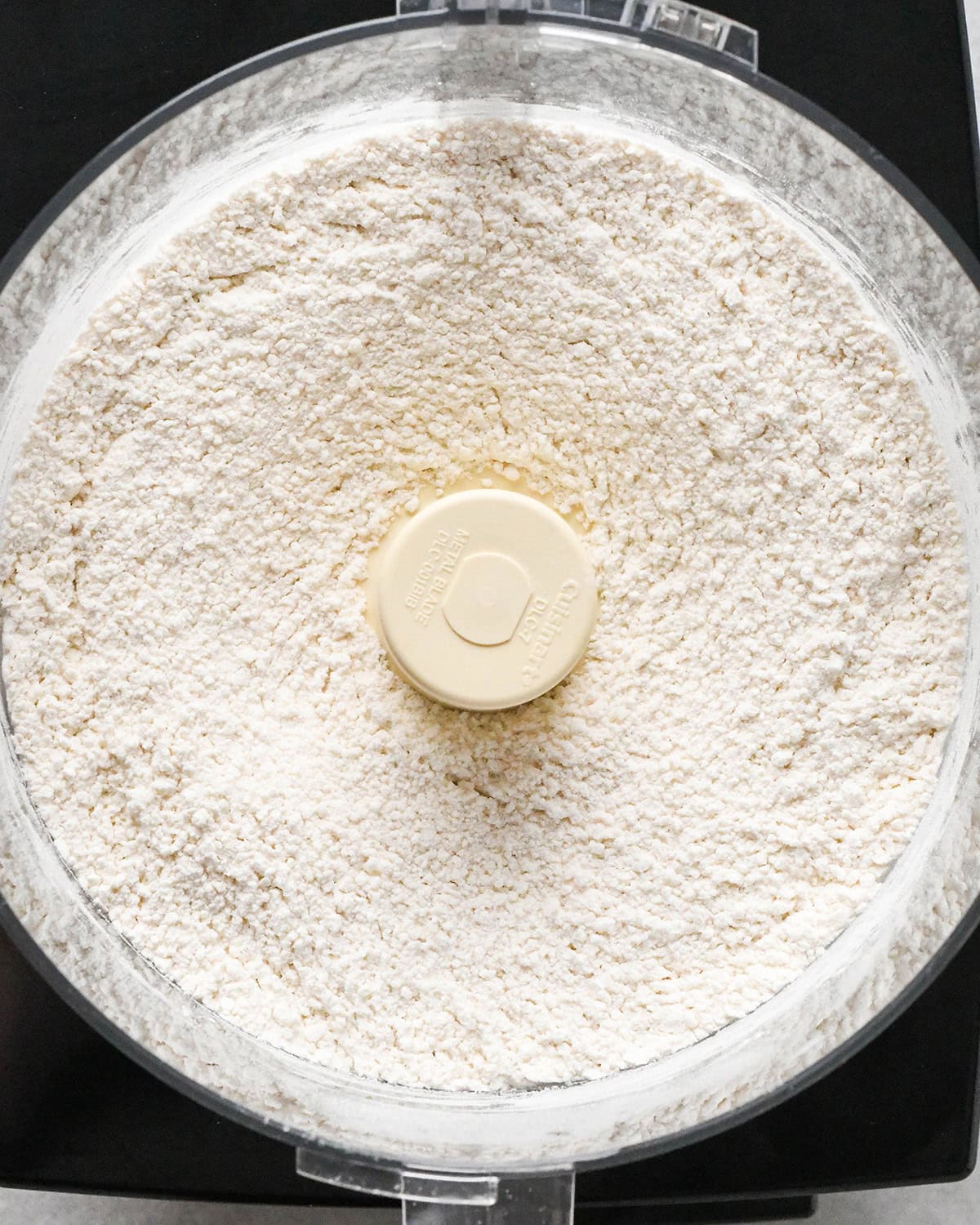 making apple cranberry pie crust - dry ingredients in a food processor after mixing