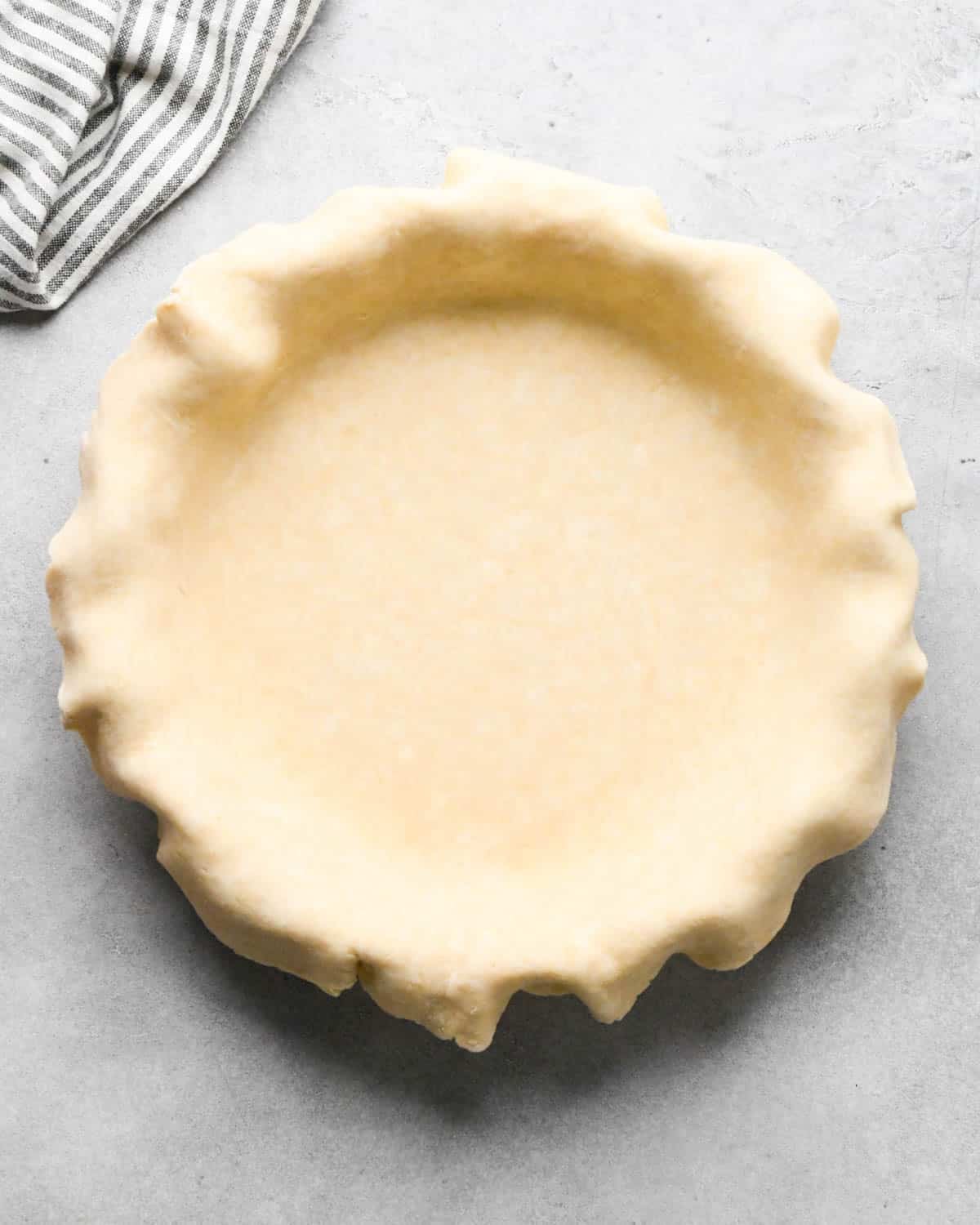 making caramel apple pie - bottom pie crust put into a pie dish