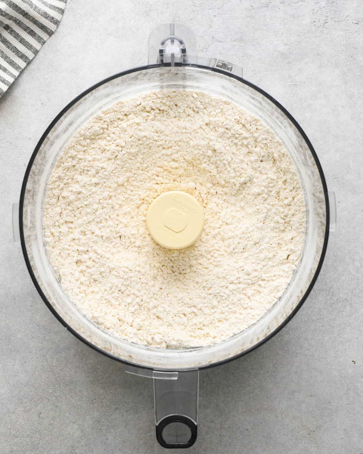 making crust for caramel apple pie - dry ingredient sin a food processor fitted with the S blade after mixing