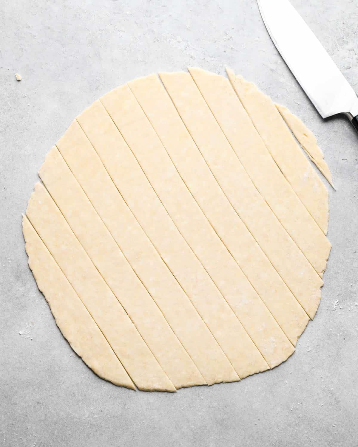 making caramel apple pie - top pie crust cut into strips for a lattice crust