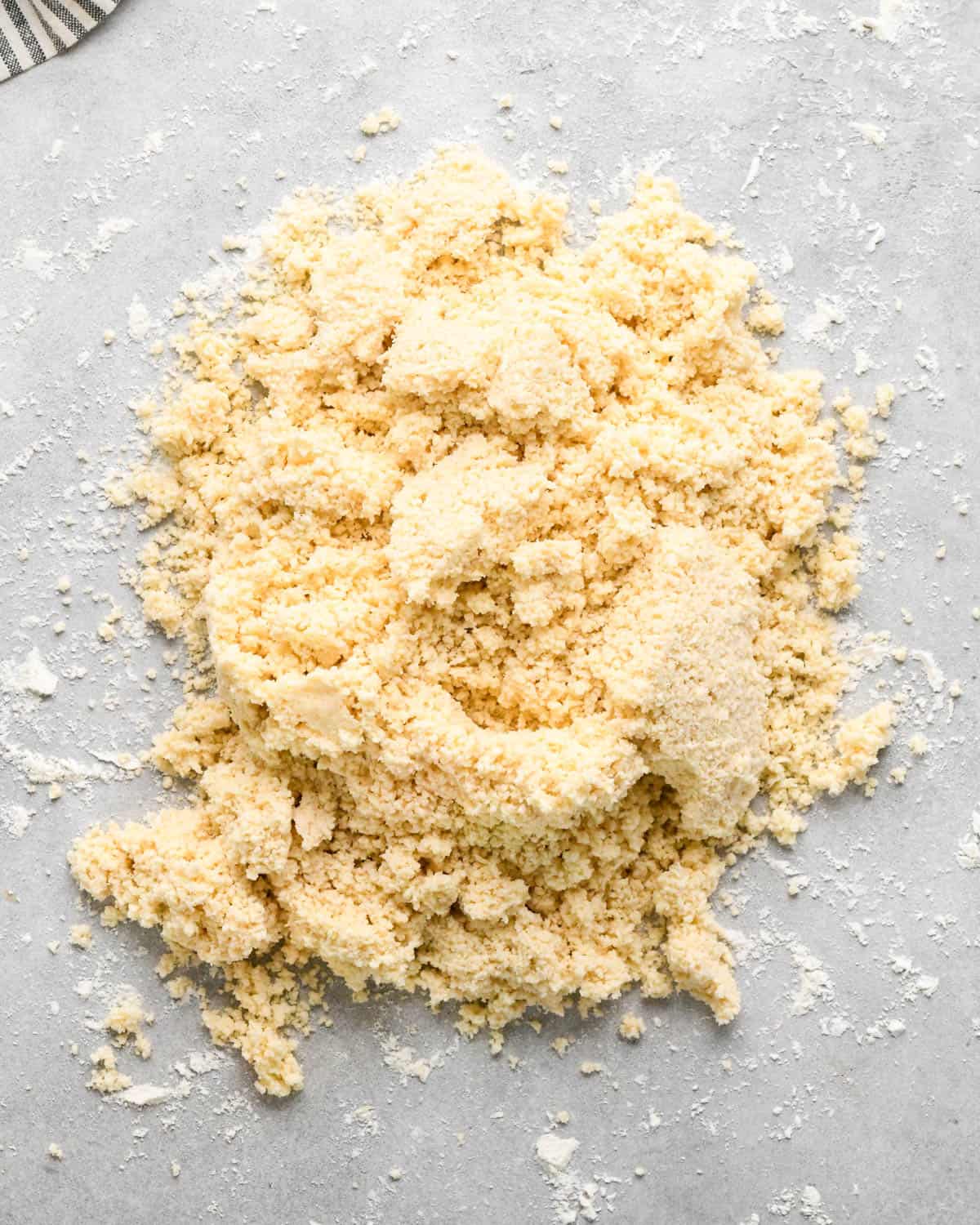 making crust for caramel apple pie - pie crust mixture on a gray floured surface