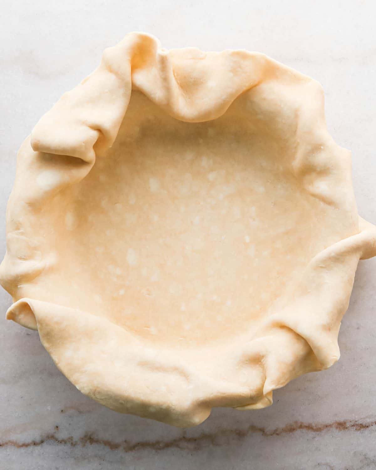 how to make pecan pie without corn syrup - pecan pie crust in the bottom of a pie dish